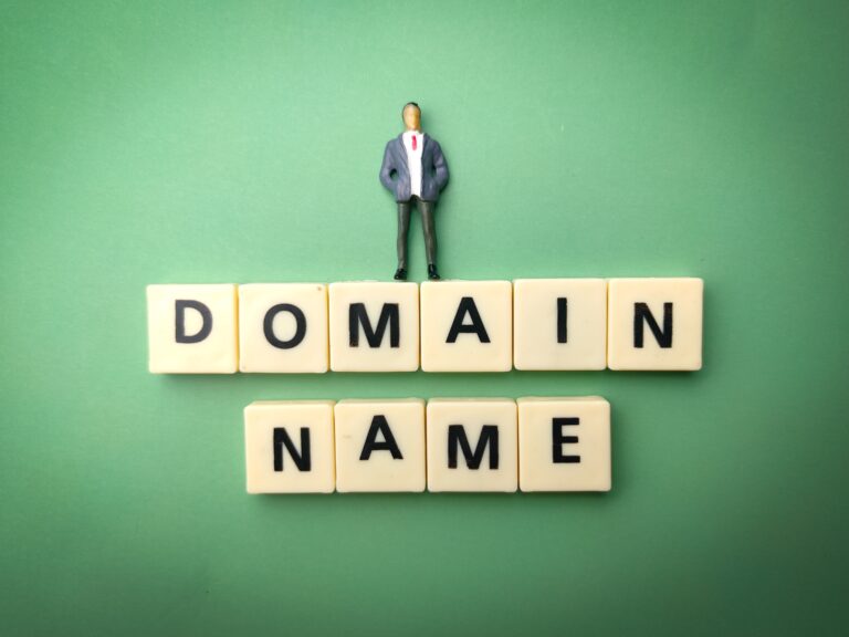 Concept image of domain name protection and online brand ownership represented by miniature figure on letter blocks