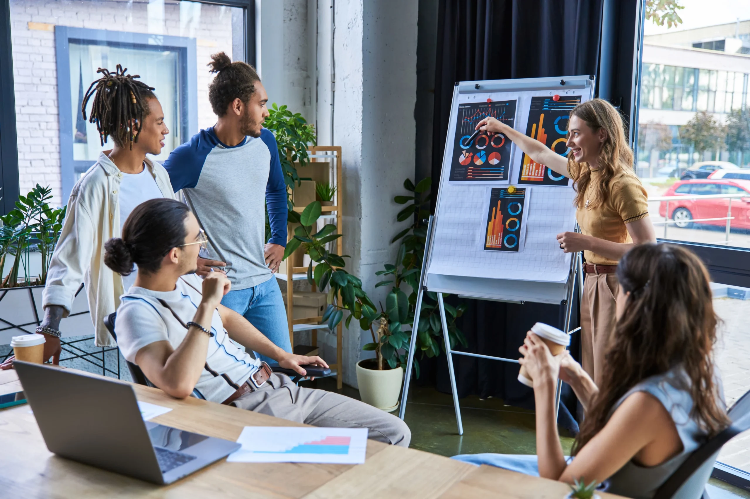 Marketing strategist presenting digital trends to a creative team on a flip chart.