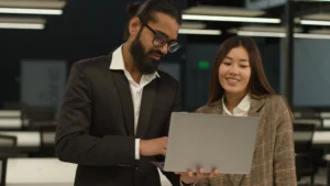 Business professionals reviewing search engine marketing and optimization results on a laptop.