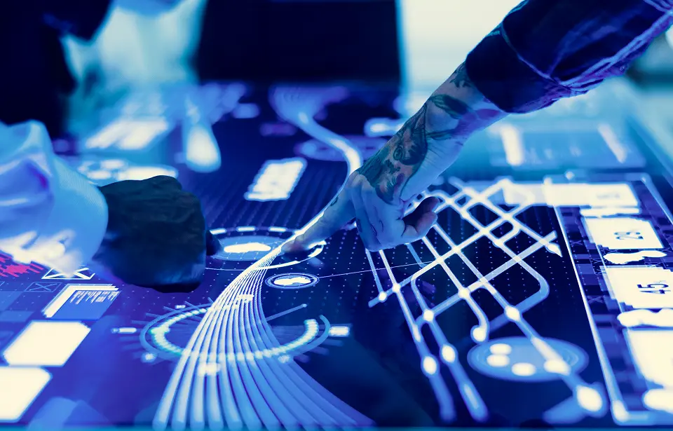 Hands interacting with a digital touchscreen displaying data visualizations and network connections.